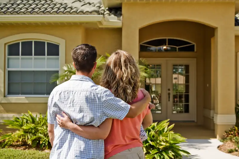 young couple outside of home
