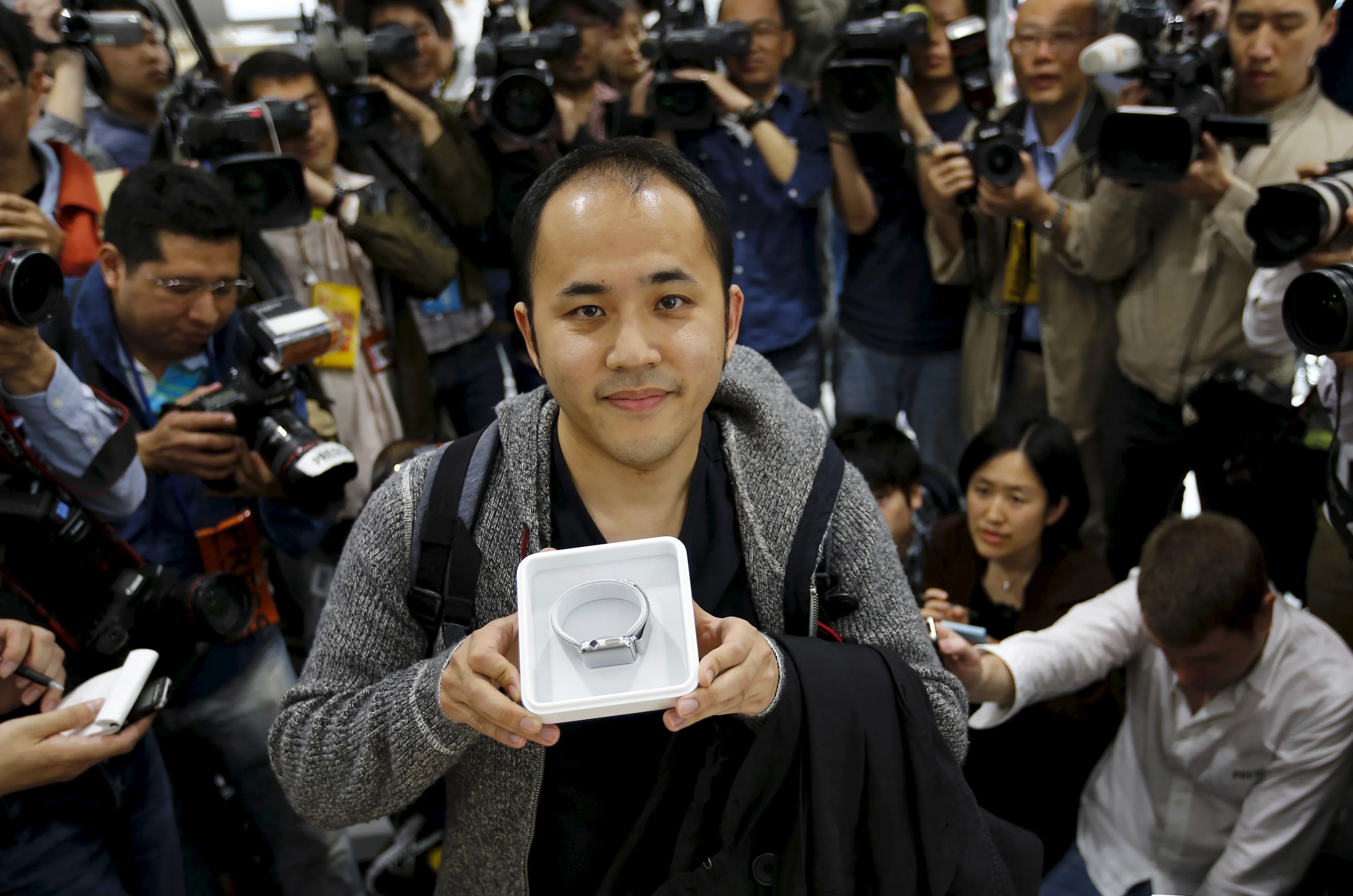 Yuichiro Masui, the first customer to purchase an Apple Watch at an electronics store in Omotasando, poses with his watch in Tokyo April 24, 2015.