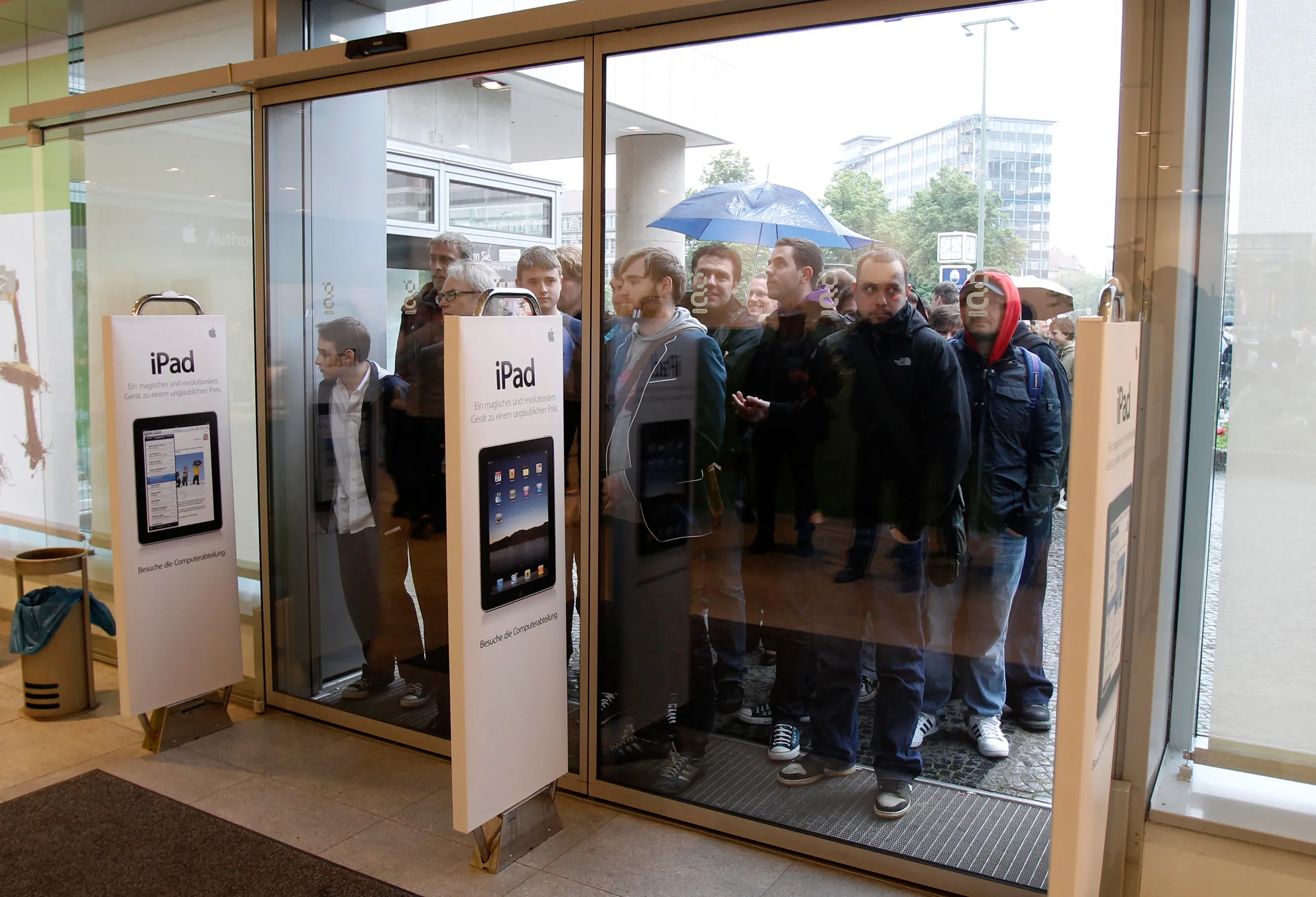 People wait in line to purchase Apple iPads during a launch event at the Apple retail store in Berlin.