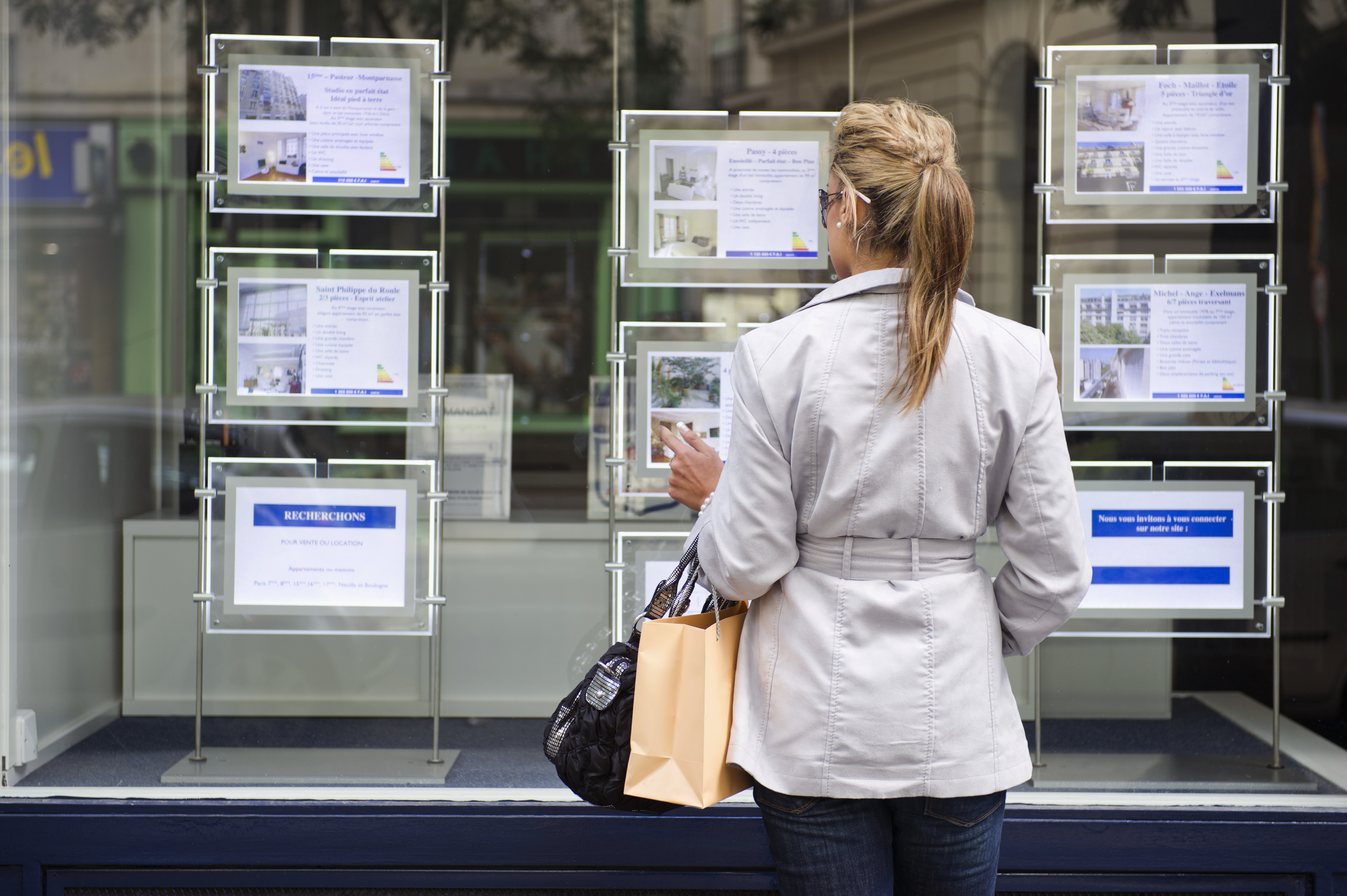 woman looking at real estate signs