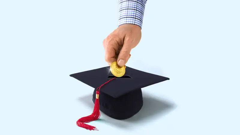 Person putting coin in mortarboard