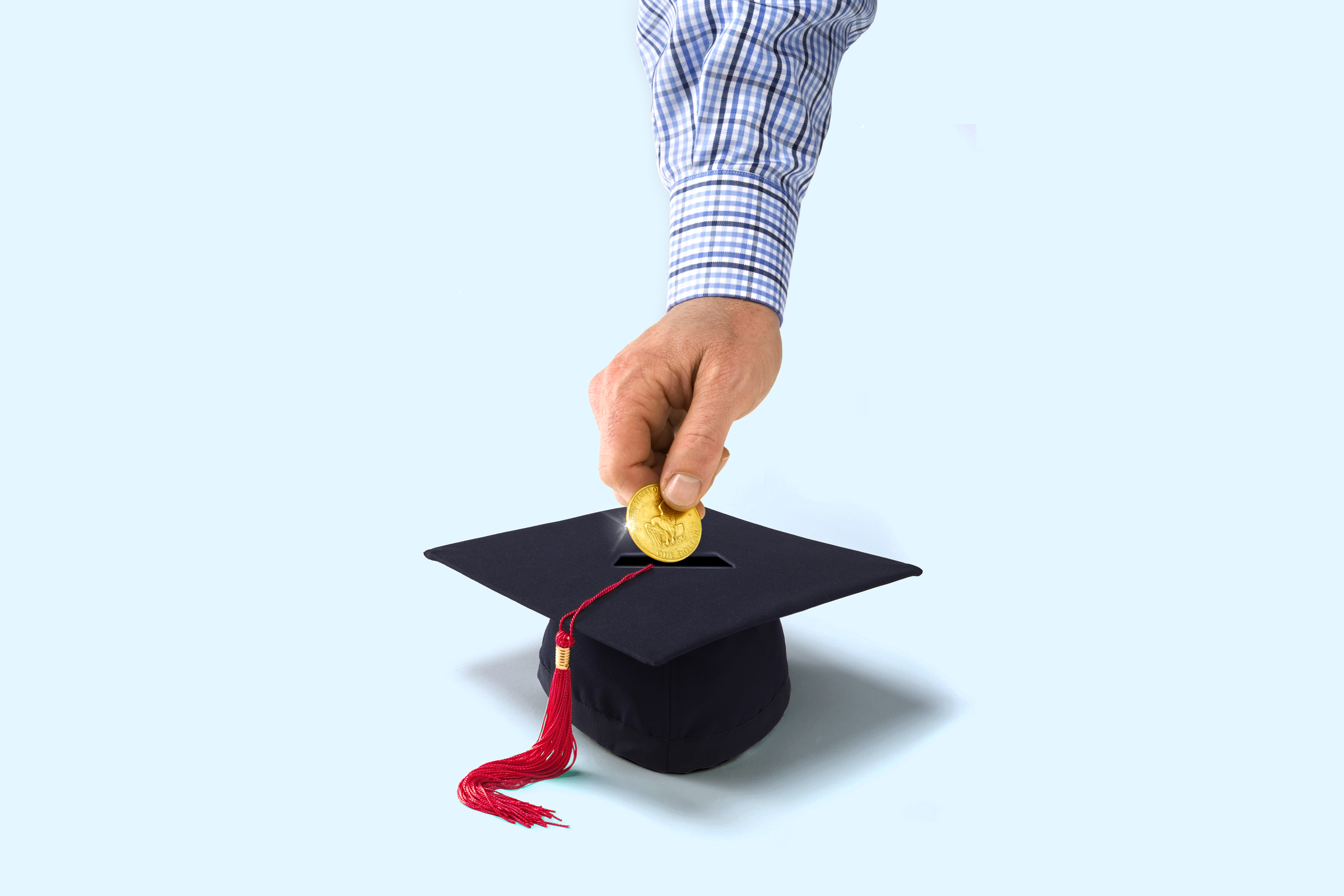 Person putting coin in mortarboard