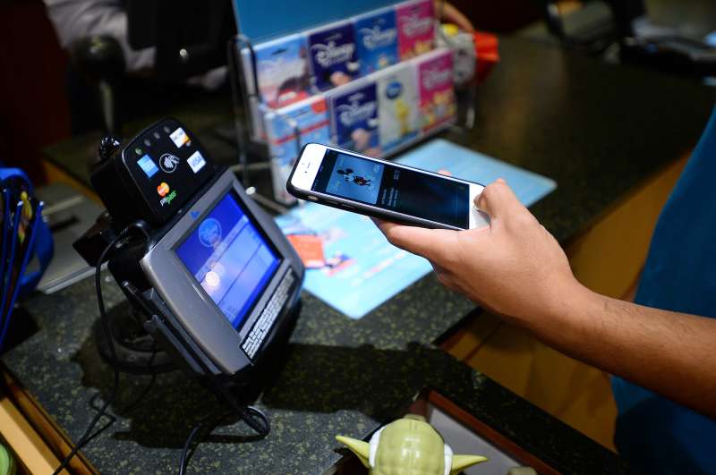 Hugo Roque of Glendale makes a purchase at a Disney Store in Glendale, CA using new Apple Pay technology.
