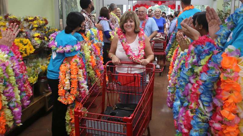 Robin Gallo (center) of North Palm Beach attended the opening on the new Trader Joe's store in Palm Beach Gardens store Friday, September 19, 2014. ''I got here at 6am and was the first in line, '' she said. ''I am using half a vacation day for this.