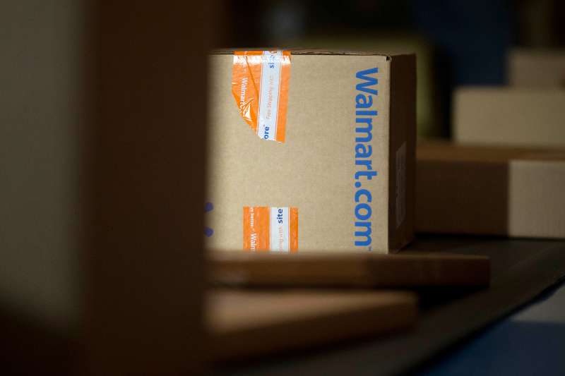 A Wal-Mart Stores Inc. package is unloaded from a trailer to be sorted for final delivery at a FedEx Corp. Ground hub in Hagerstown, Maryland, U.S.