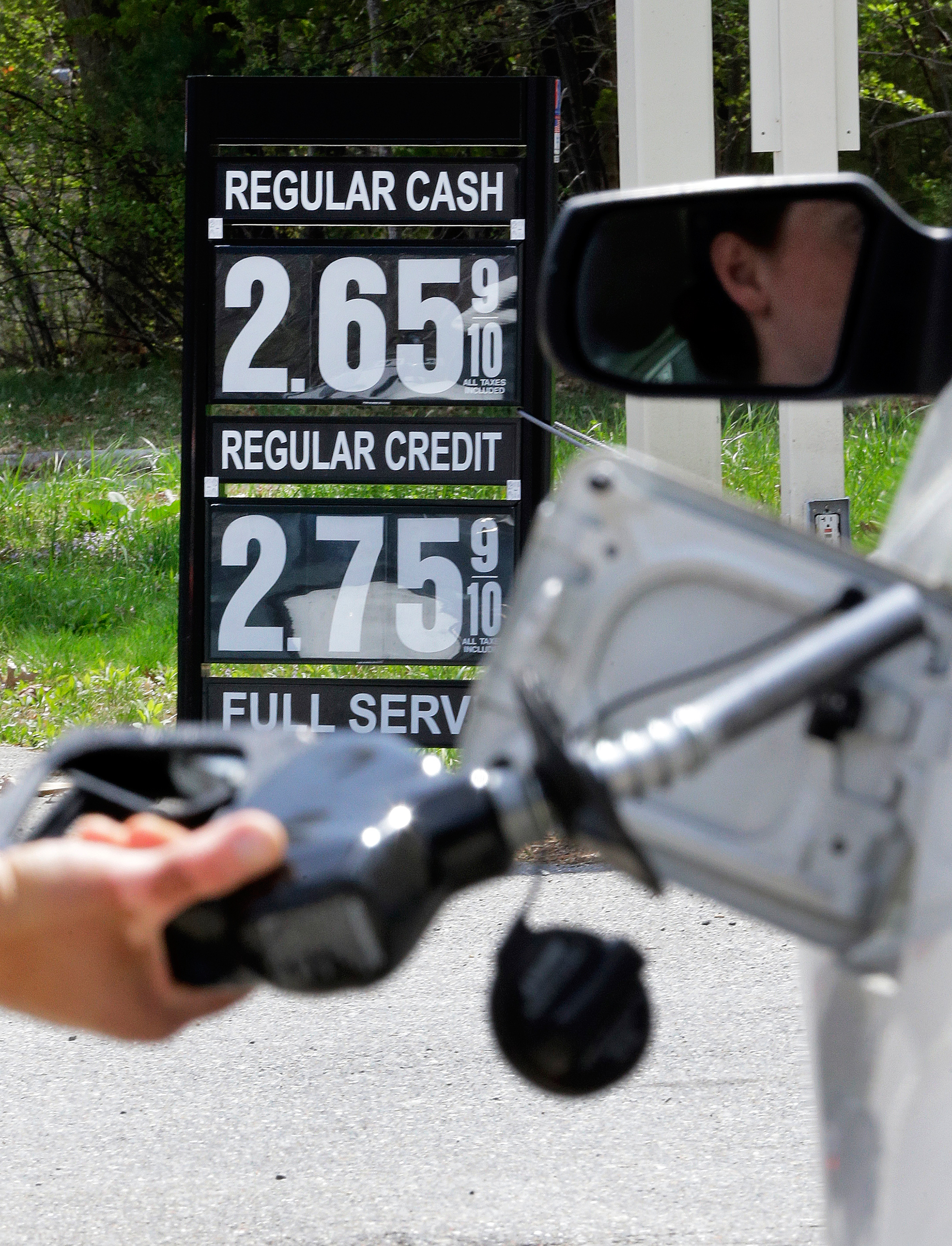 Gas station attendant pumping gas in Andover, Mass., May 8, 2015.