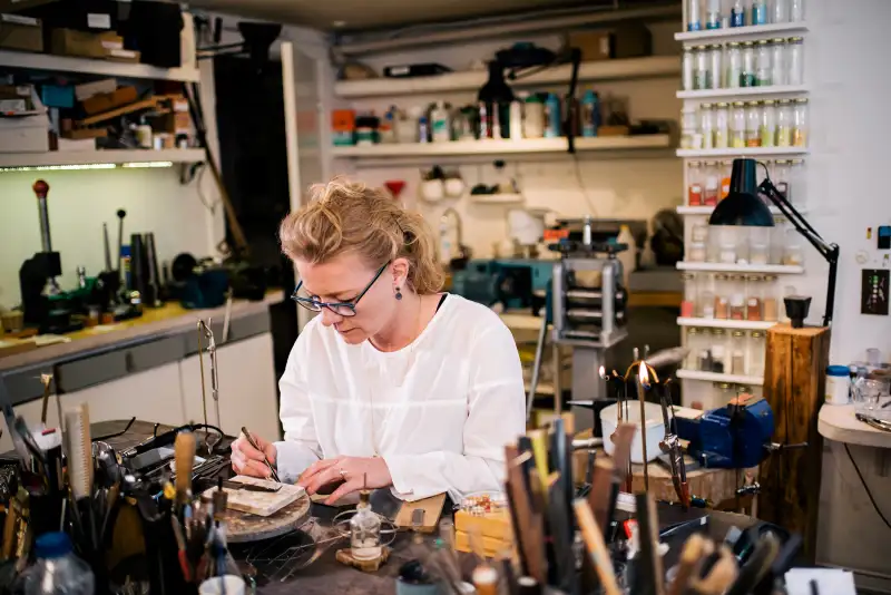 woman working on jewelry in shop