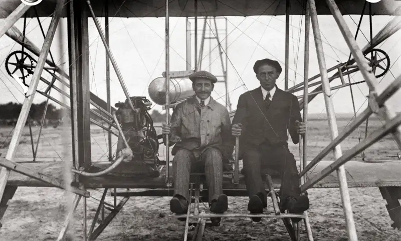 Wilbur Wright, American pioneer in aviation, and Paul Zens, famous French flier, preparing for two man flight in Le Mans, France, September 16, 1908.