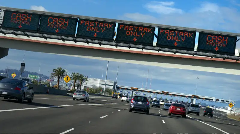 Toll Booths and Fastrak signs on gantry over Interstate 80 highway to San Francisco City, California