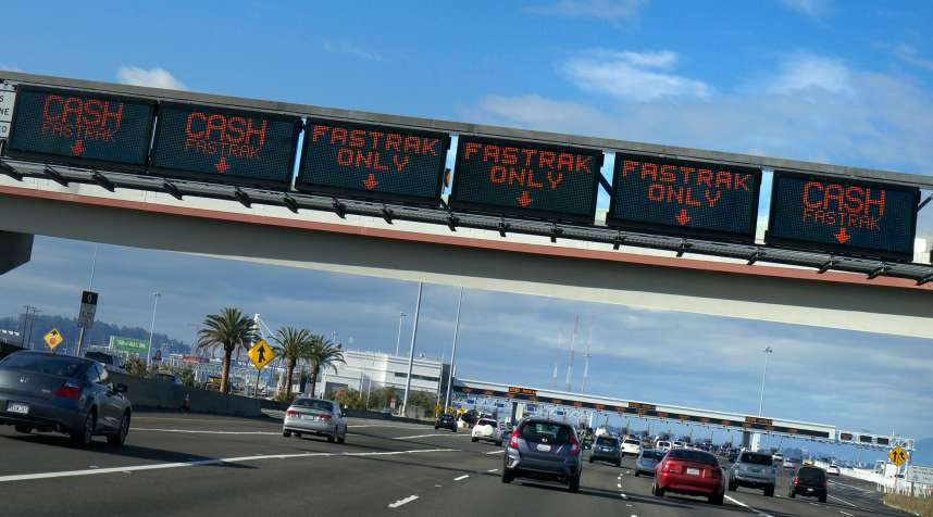 Toll booths and Fastrak signs on gantry over Interstate 80 highway to San Francisco City, California