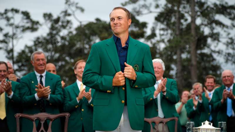 Jordan Spieth of the U.S. grins as he wears his Champion's green jacket on the putting green after winning the Masters golf tournament at the Augusta National Golf Course in Augusta, Georgia April 12, 2015.