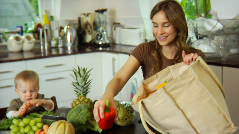 Woman unloads shopping bag illustrating inflation