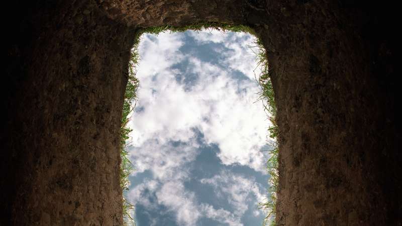 view from inside a grave to the sky