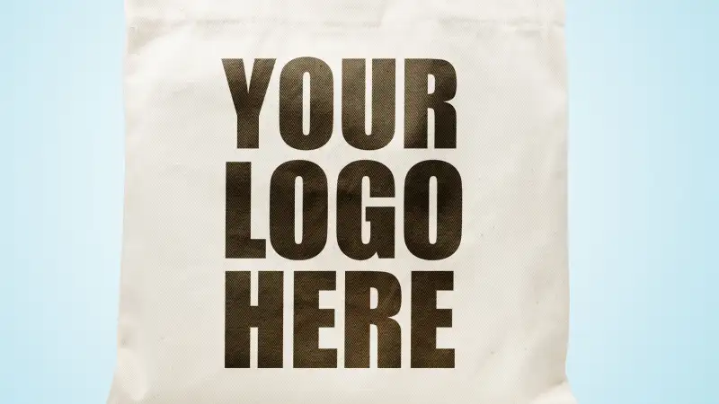 Your Logo Here written on canvas tote bag