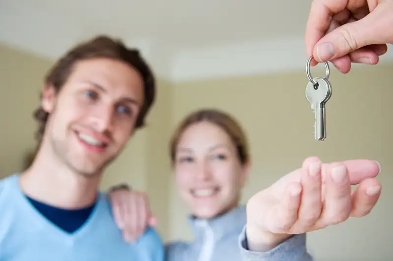 couple taking keys to house