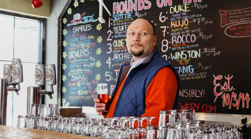Beer Hound Brewery brew master and owner Kenny Thacker is seen behind the bar at the Beer Hound Brewery in Culpeper, VA on Sunday, February 22, 2015.
