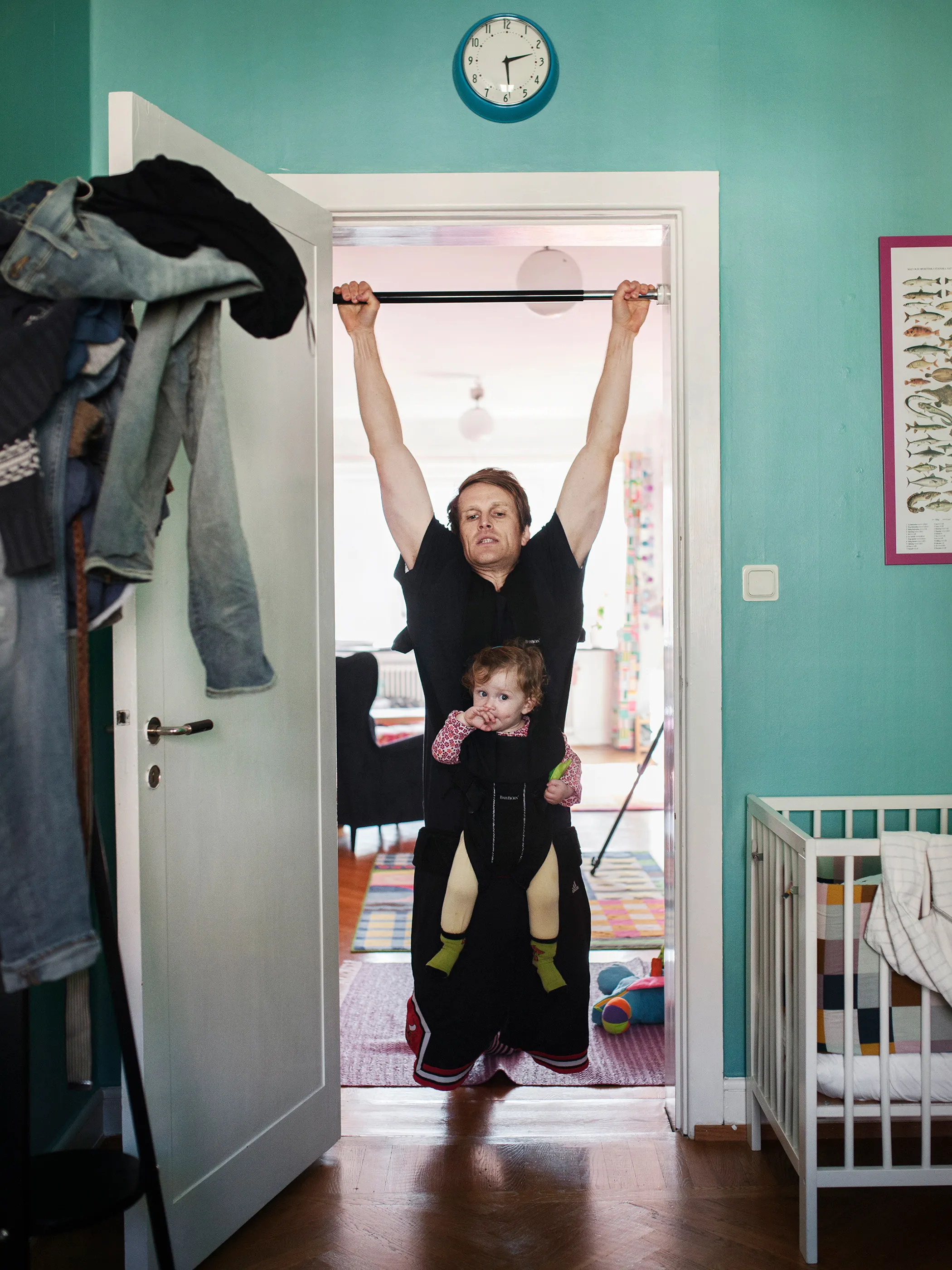 PETER HERKEL, 33, journalist, with daughter Mira. <b>Parental Leave:</b> Ten months. "The exercise mode emerged during one of many sleepless nights when I was up with our daughter Mira. She went quiet when I did knee bends in the middle of the night with her in the Baby Bjorn Carrier and I felt that 'finally I can also comfort my daughter.'" 