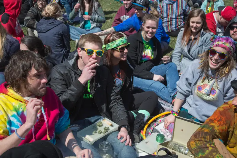 crowd of people smoking marijuana