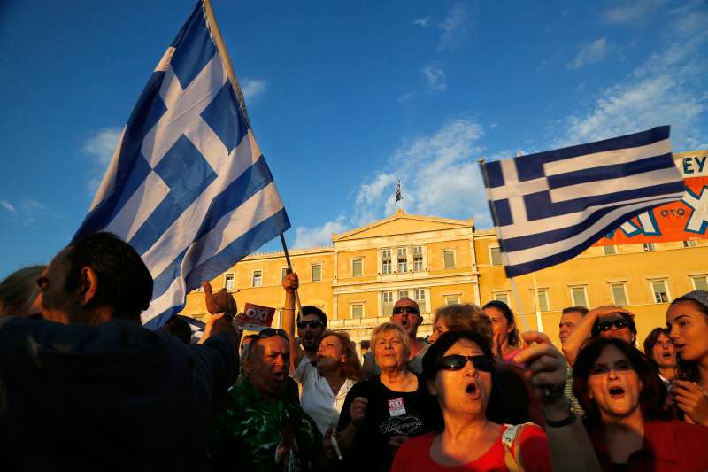 Supporters of the NO vote in the upcoming referendum, gather during a rally at Syntagma square in Athens on Monday, June 29, 2015. Anxious Greek pensioners swarmed closed bank branches and long lines snaked outside ATMs as Greeks endured the first day of serious controls on their daily economic lives ahead of a July 5 referendum that could determine whether the country has to ditch the euro currency and return to the drachma.