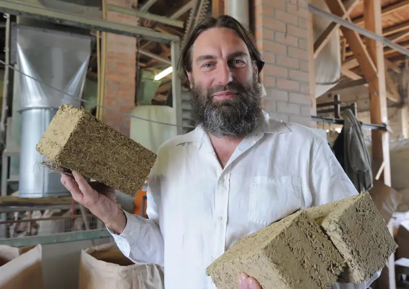 Rainer Nowotny, managing director of the company Hemp fibre Uckermark eG, presents bricks made of clay and hemp in Prenzlau, Germany, July 24, 2013.