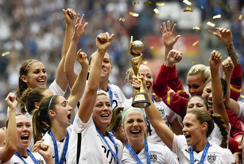 USA teammates hold the trophy following the teams' win in the final 2015 FIFA Women's World Cup match between USA and Japan at the BC Place Stadium in Vancouver on July 5, 2015.