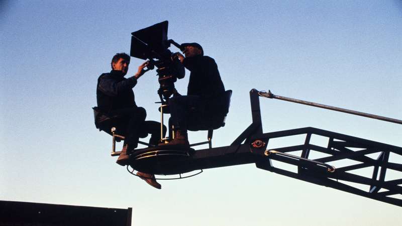 film director and movie camera on cherry picker