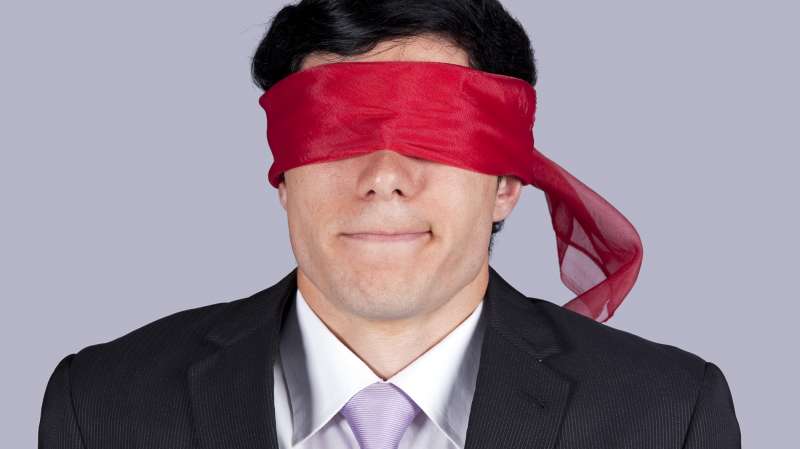 blindfolded man in suit