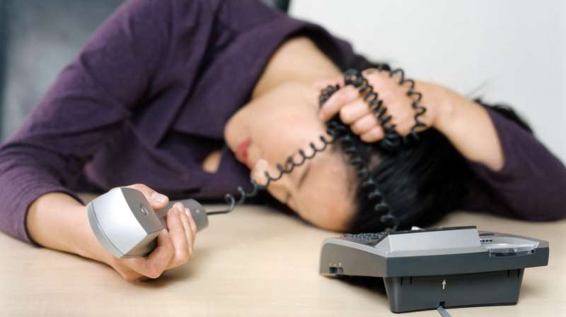 person asleep with phone on desk