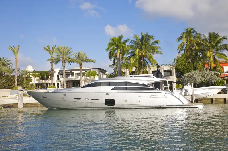 yacht in front of Miami mansions