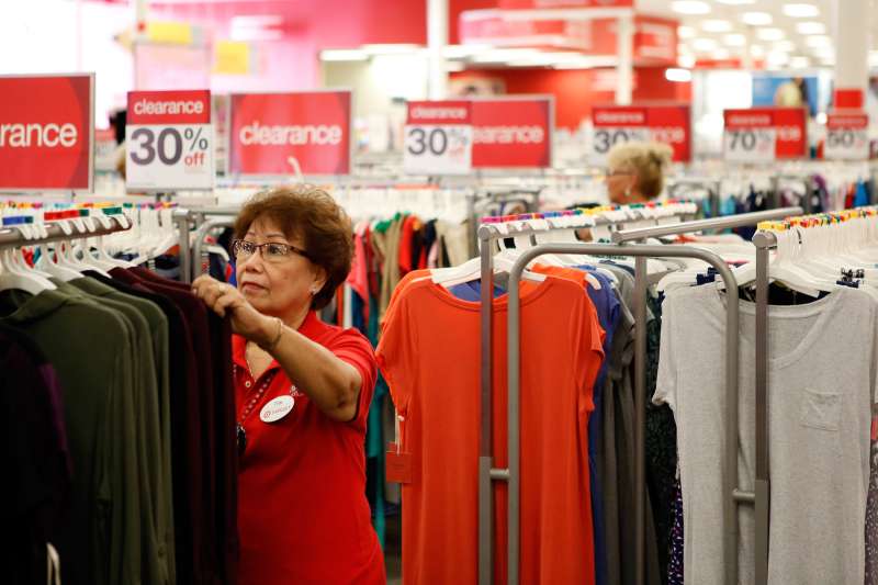 target employee organizing t-shirts and apparel in target store