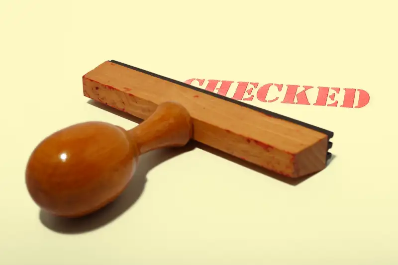 rubber stamp that says checked