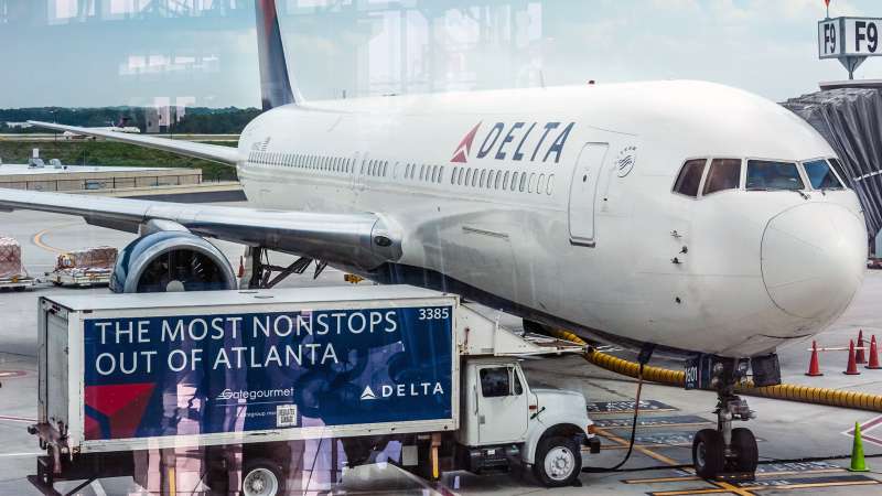Delta Airlines passenger jet and service truck at Atlanta International Airport in Atlanta, Georgia, 2014.