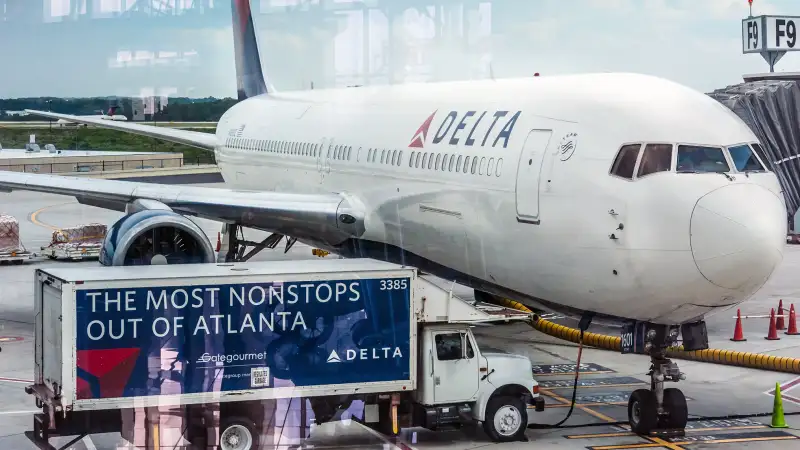 Delta Airlines passenger jet and service truck at Atlanta International Airport in Atlanta, Georgia, 2014.