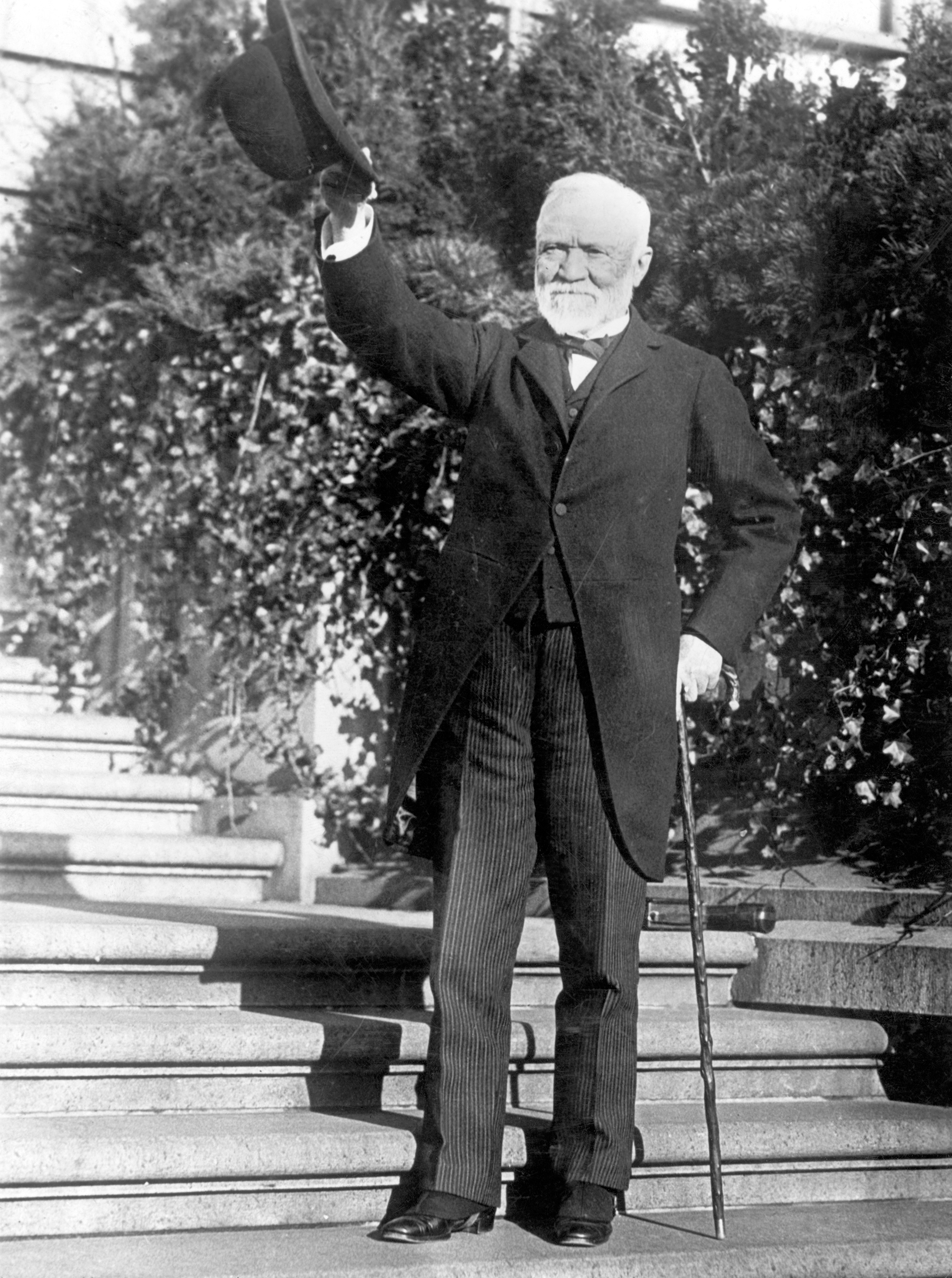 Andrew Carnegie standing on the steps of his estate, circa 1910s.