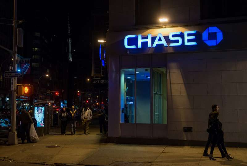 Pedestrians stroll past a Chase bank branch on 12th Street and Broadway in Manhattan,  New York, U.S., on Saturday, April 11, 2015.  Photographer: Craig Warga/Bloomberg *** Local Caption ***