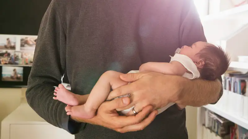 Father holding newborn