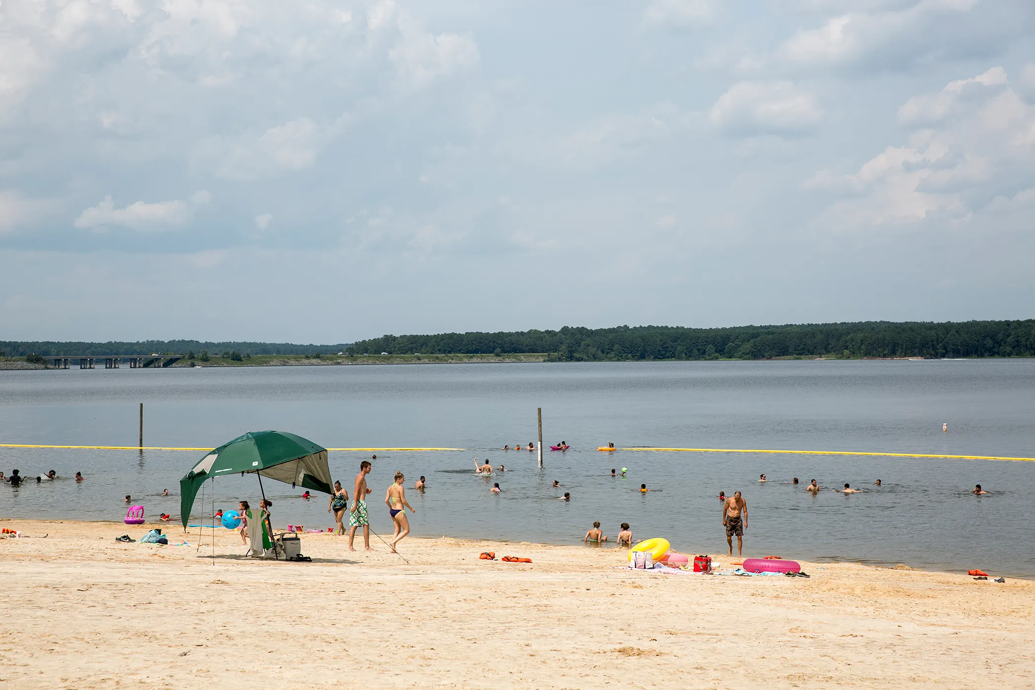 Visitors enjoy the beach at the Jordan Lake State Recreation Area outside of Apex, NC