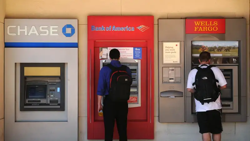 college students with backpacks at atm machines