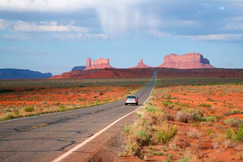 car on long straight desert road