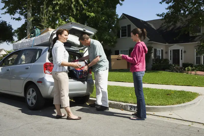 parents helping daughter pack for college