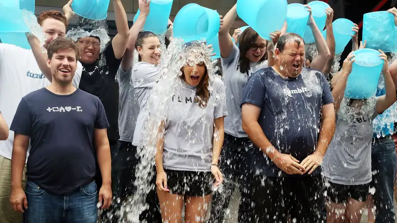 Ken Little, VP Engineering at Tumblr, Katherine Barna, Head of Communications at Tumblr, and Lee Brown, Head of Global Sales at Tumblr accept the ALS Ice Bucket Challenge during the ringing of the opening bell at the NASDAQ MarketSite on August 21, 2014 in New York City.