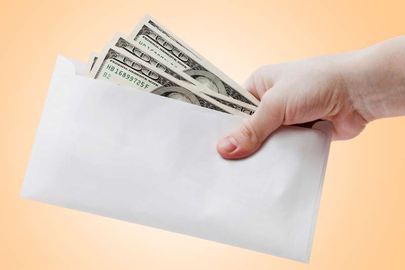 hand with envelope of money
