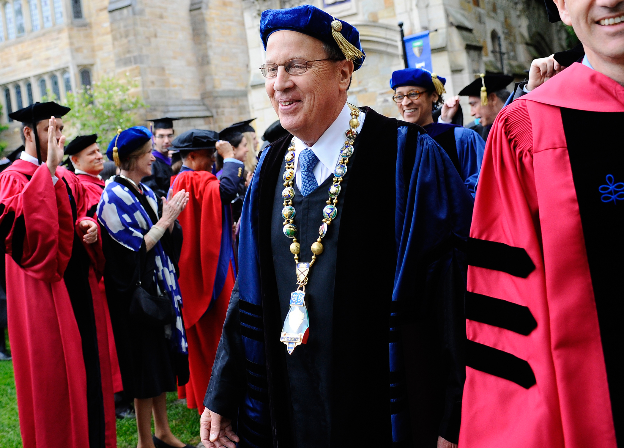 Yale President Richard Levin smiles as he walks in his final procession during commencement at Yale University in New Haven, Connecticut