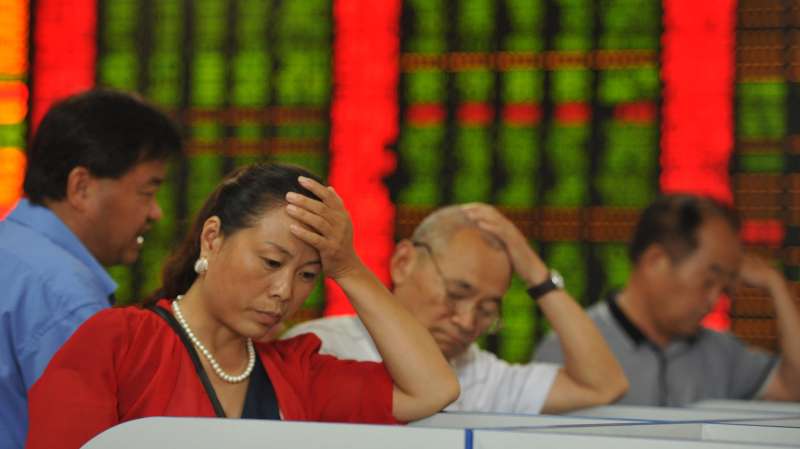 Investors watch computer screens at a stock exchange hall on August 18, 2015 in Fuyang, China. Chinese shares plunged on Tuesday with the benchmark Shanghai Composite Index down 245.51 points, or 6.15 percent, to close at 3,748.16. The Shenzhen Component Index fell 890.04 points, or 6.56 percent, to close at 12,683.86.