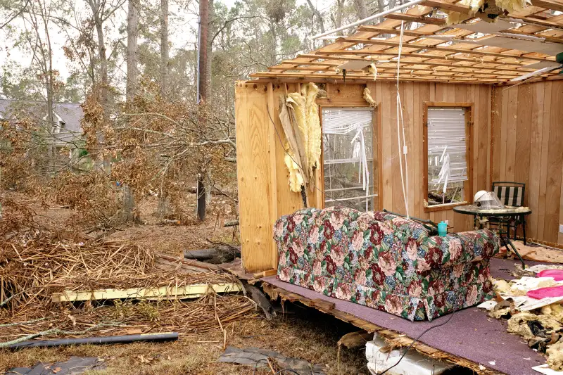 Walls and ceiling of house blown away, exposing living room, aftermath of Hurricane Katrina, Sulphur