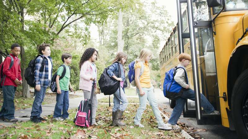 children boarding school bus