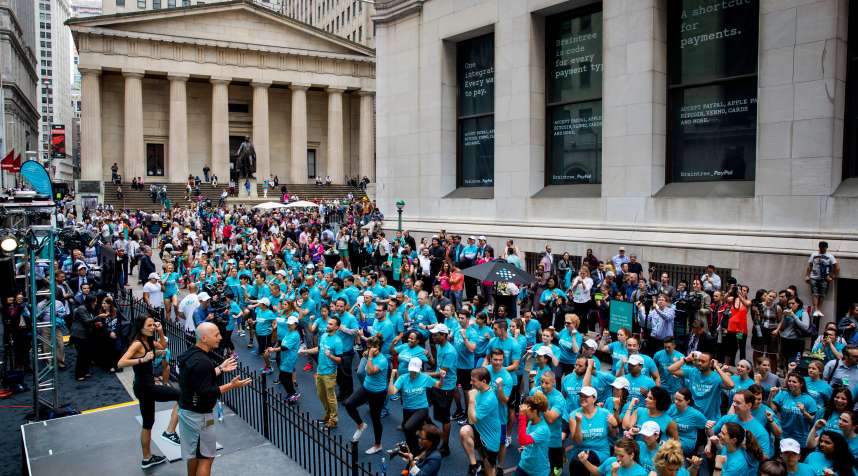 Celebrity fitness trainer Harley Pasternak and actress Jordana Brewster lead a Fitbit lunchtime workout event outside the New York Stock Exchange during the IPO debut of the company on June 18, 2015 in New York City.