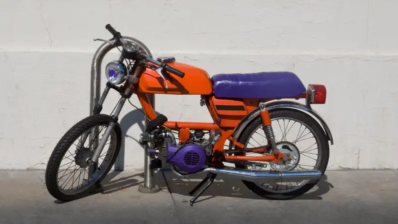 A purple and red moped on the sidewalk at Fisherman's Wharf, San Francisco