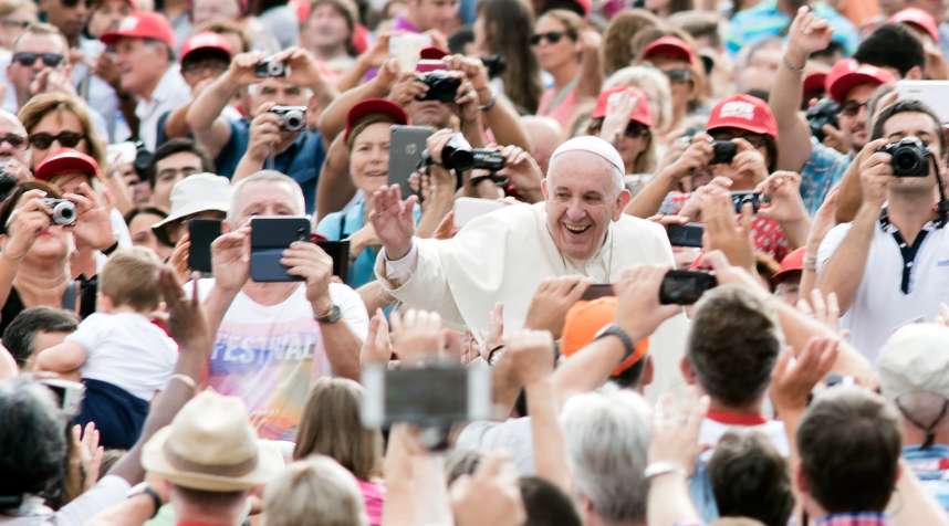 Pope Francis accompanied by his security agents, waves to faithful upon his arrival on St Peter's square at the Vatican to lead his weekly general audience on September 16, 2015.