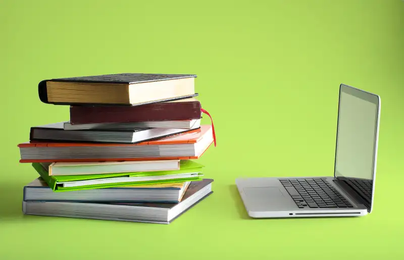 stack of books and laptop